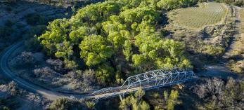 A historic bridge on Wagoner Road spans the cottonwood-lined Hassayampa River. By Rebecca Wilks