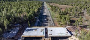 This photograph, made with a drone, shows a new wildlife bridge under construction over Interstate 17 between Munds Park and Flagstaff. | LAURENCE PARENT