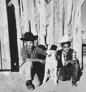 A young Begay (right) and his brother Nelson pose with a dog in the Kletha Valley, near the town of Shonto, in the 1960s. | Courtesy of Shonto Begay