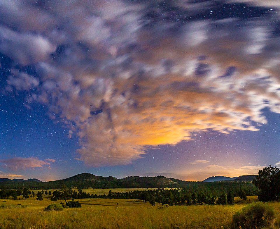 Clouds catch the day’s last light over a meadow in the Flagstaff area. Renowned for its pristine nighttime skies, Flagstaff was recognized in 2001 as the world’s first International Dark Sky Place, a designation now shared by several other Arizona sites. By Byron Neslen