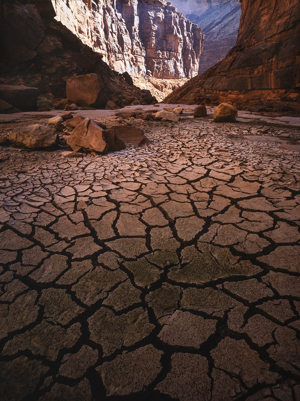 Jagged cracks, the result of water drying up after summer rains have ended, define a September view of North Canyon. This side canyon empties into Marble Canyon around river Mile 21. By Gary Ladd
