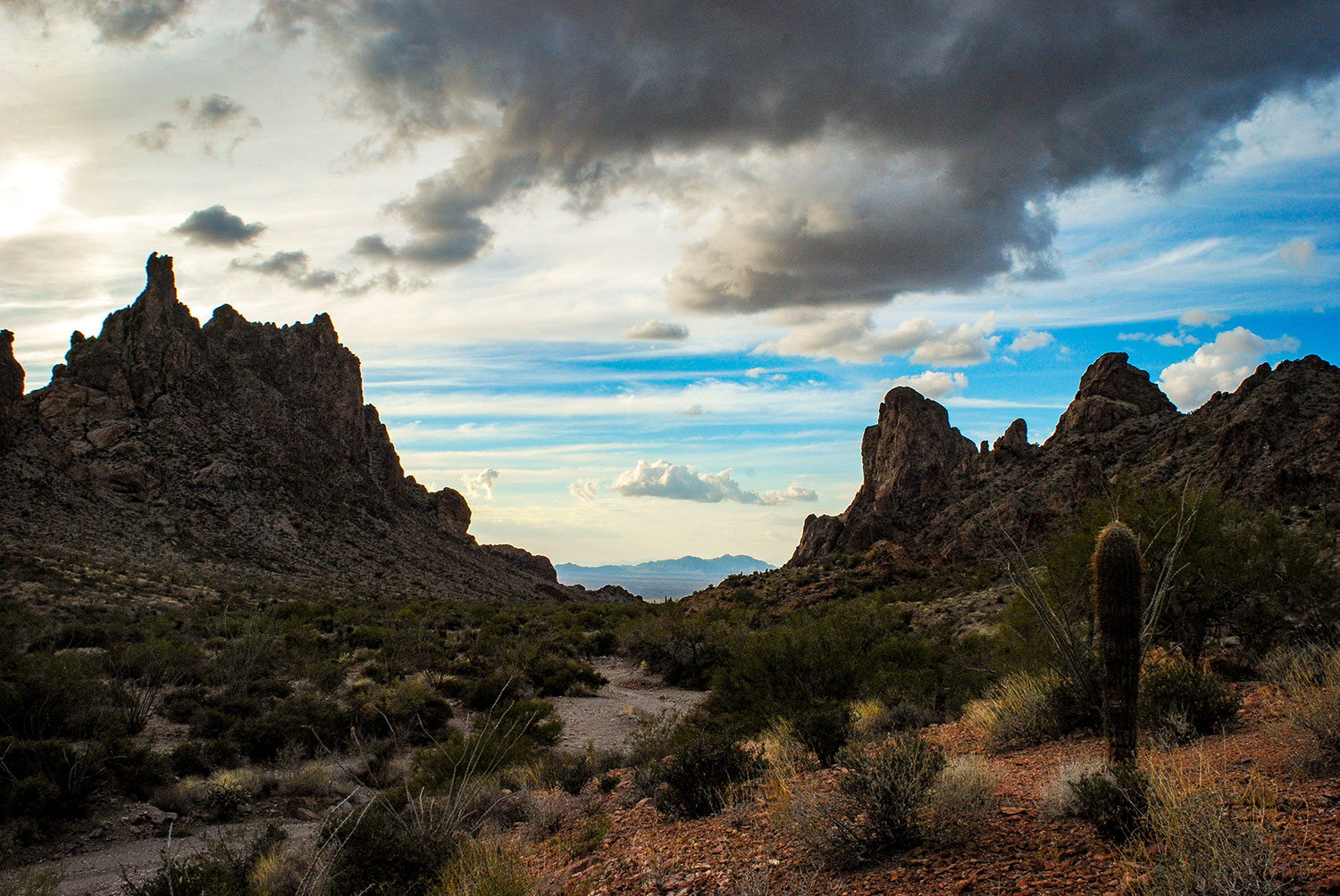 A streambed leads westward under darkening skies in the Kofa Mountains, near Quartzsite. By Kirk Higgins