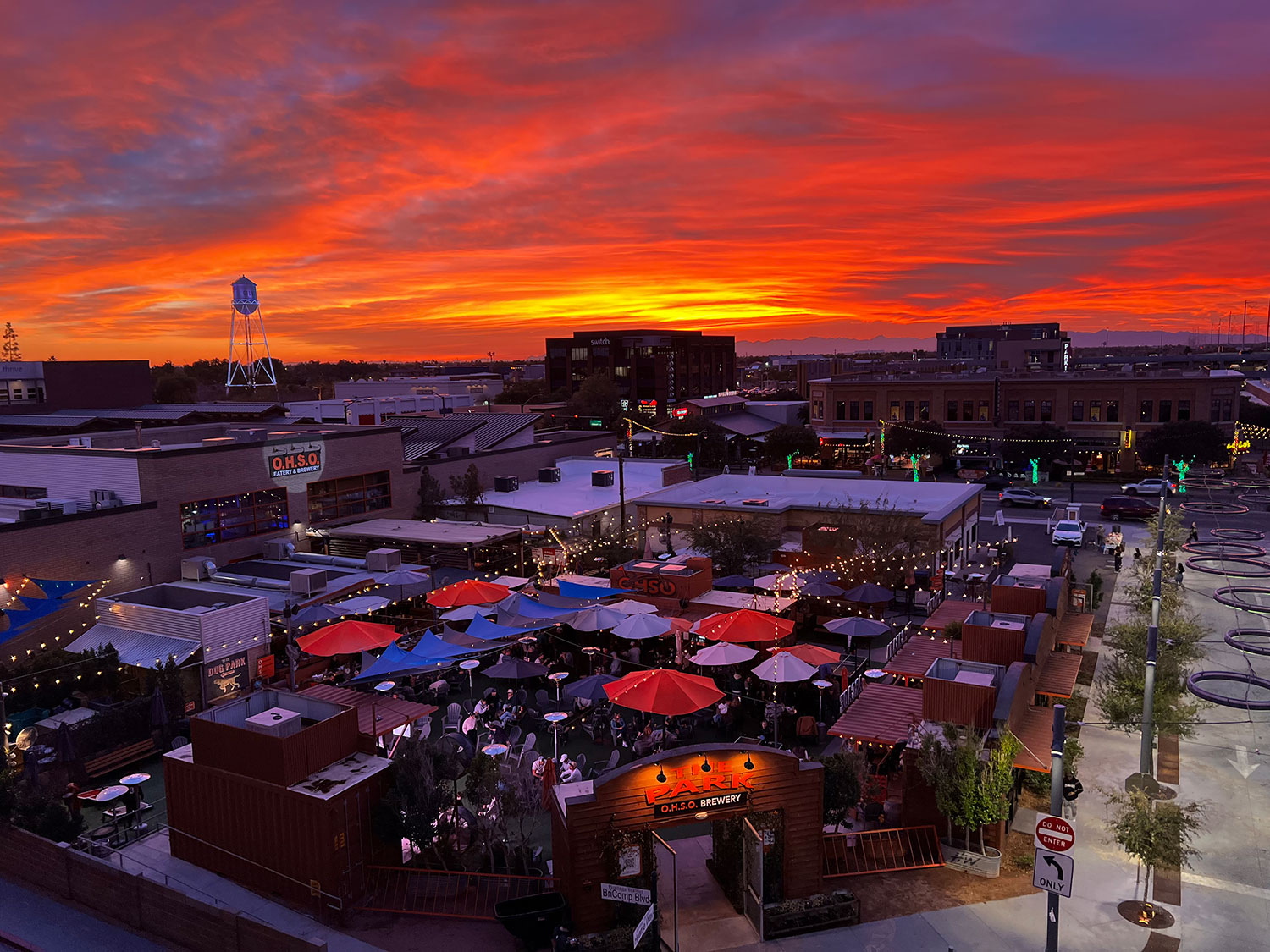 The colors of sunset fill the sky over equally vibrant downtown Gilbert. By Kyra Blaksley