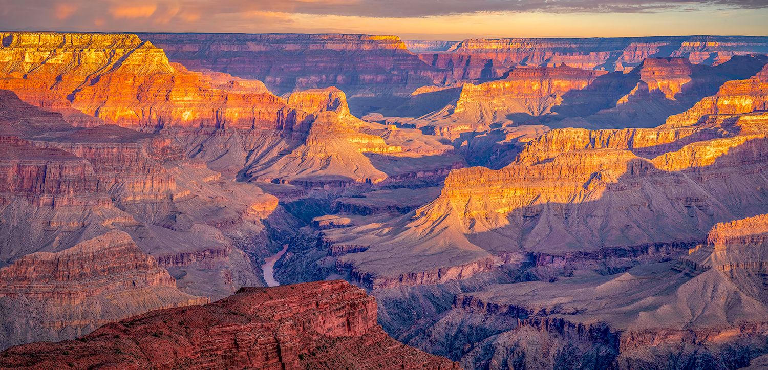 A panorama from the South Rim of the Grand Canyon includes a passing storm at sunrise. By Stephen Malaska