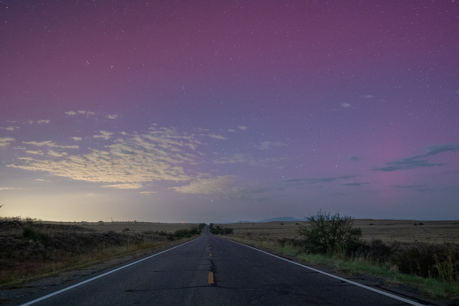 State Route 83 bisects a Southern Arizona grassland beneath the glow of the northern lights. By Wendy Islas