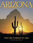 The April 2025 cover of Arizona Highways features a double exposure made by David Muench of silhouetted saguaros at sunset with a mountain backdrop.