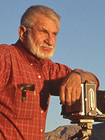 Jerry Jacka poses with a 4x5 camera mounted on a tripod in the Arizona desert. | COURTESY OF THE JACKA FAMILY