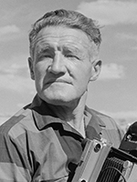 BW photo of Josef Muench posing with 4x5 camera. | NORTHERN ARIZONA UNIVERSITY CLINE LIBRARY