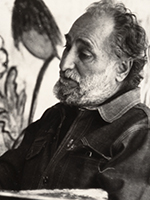 Ted DeGrazia stands with brushes and palette in front of a mural-sized painting. COURTESY OF DeGRAZIA GALLERY IN THE SUN 