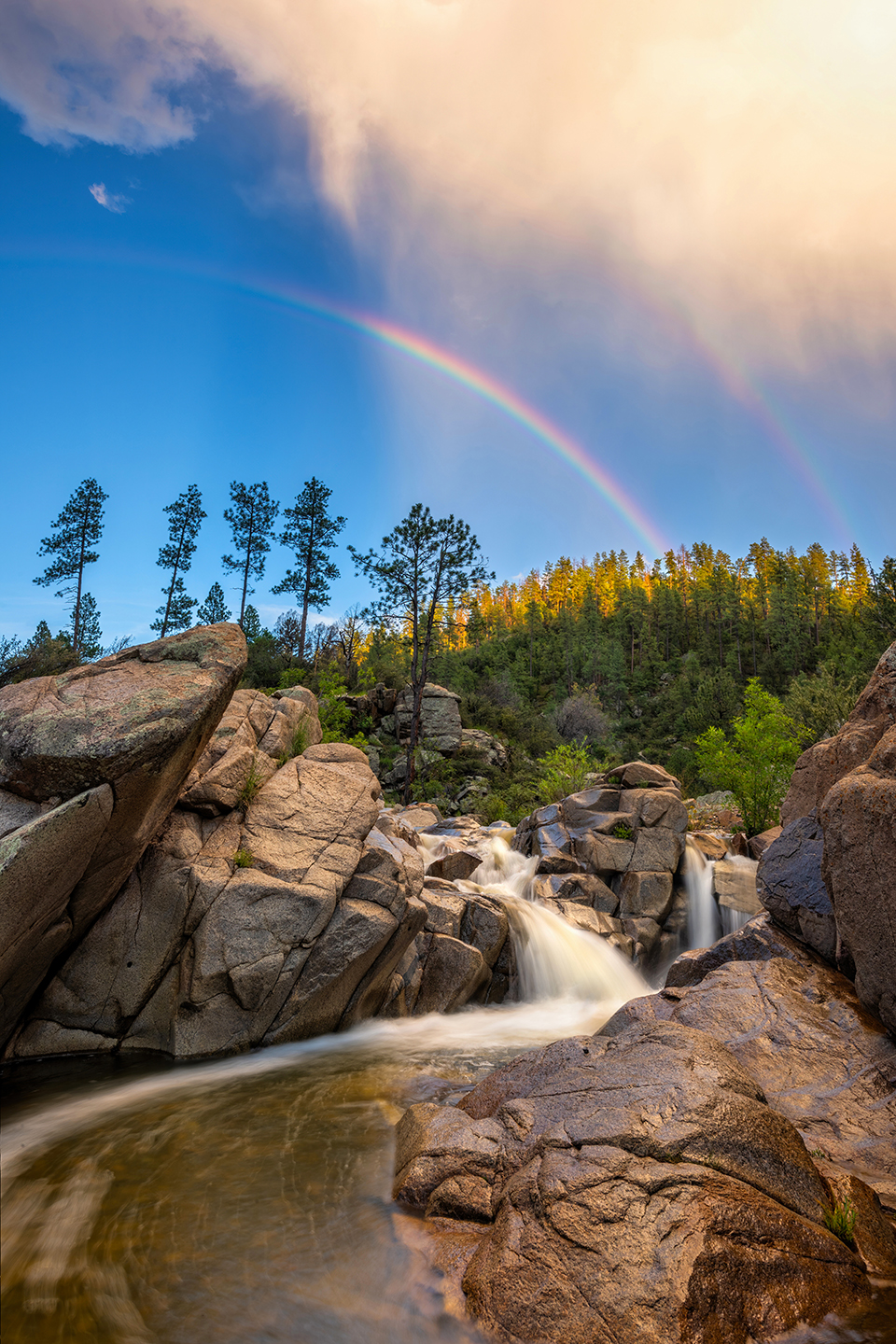The arc of a rainbow parallels the curve of a waterfall on Indian Creek, a tributary of the Hassayampa River. The creek, which flows seasonally, empties into the Hassayampa south of Prescott. | Theresa Rose Ditson