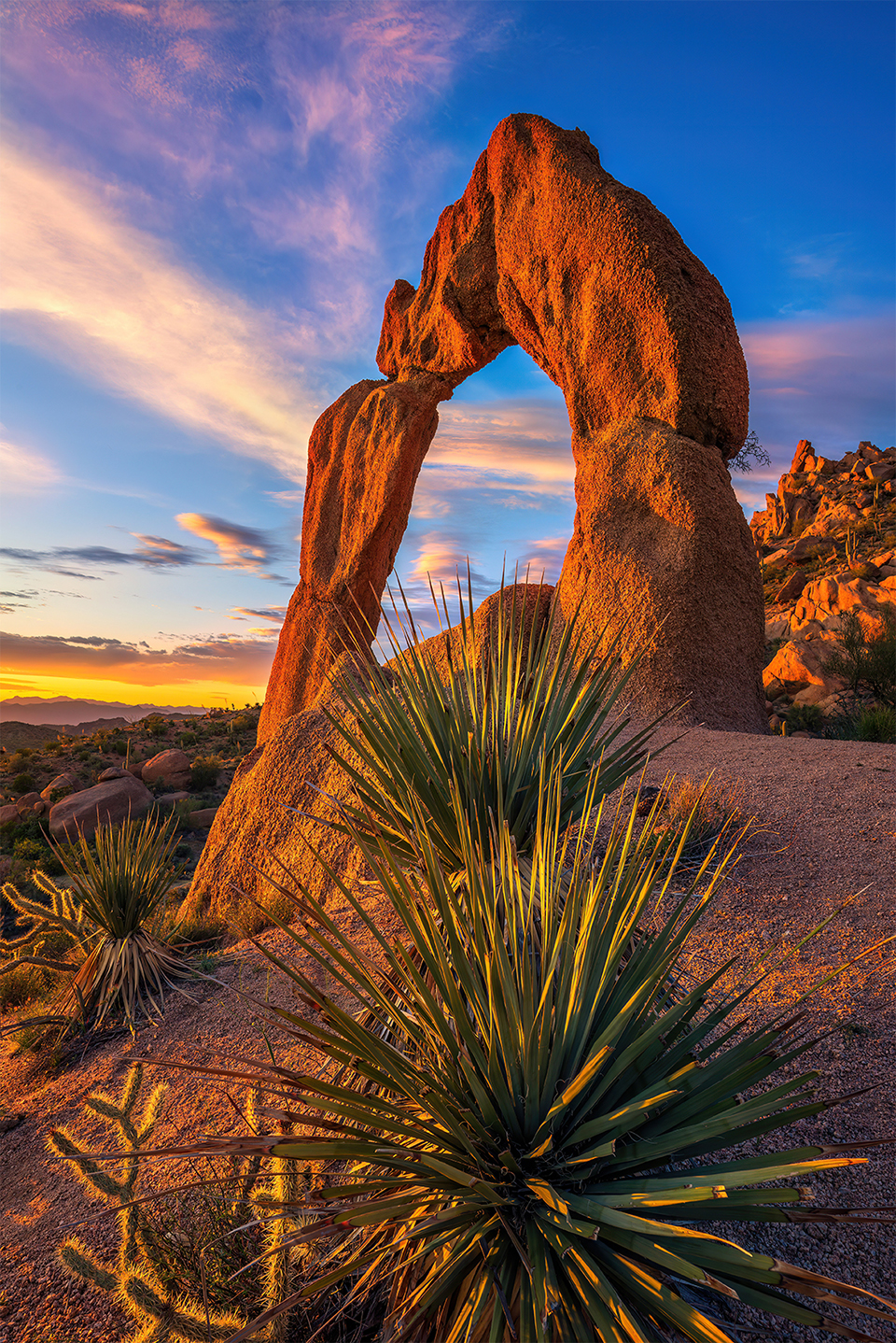 Scorpion Arch stands tall and majestic under a sky that was shrouded in a thick blanket of clouds that dispersed and 'danced' into various patterns at sunset. By Theresa Rose Ditson