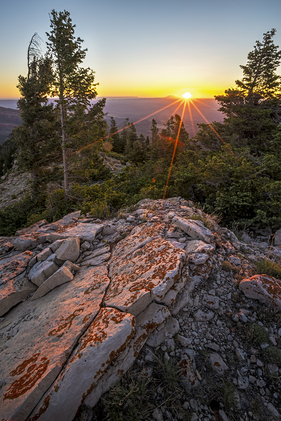 The rising sun warms a rocky outcropping at Marble Viewpoint, a remote Kaibab Plateau overlook. This viewpoint is accessible via a series of Kaibab National Forest roads. By Rebecca Wilks
