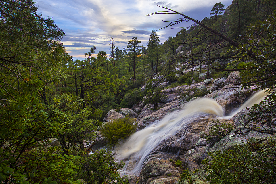 A waterfall flows over weathered rocks in Palisade Canyon, part of the Tucson area’s Santa Catalina Mountains. Exploring this remote canyon is a challenge that often involves technical canyoneering and rappelling. Joel Hazelton