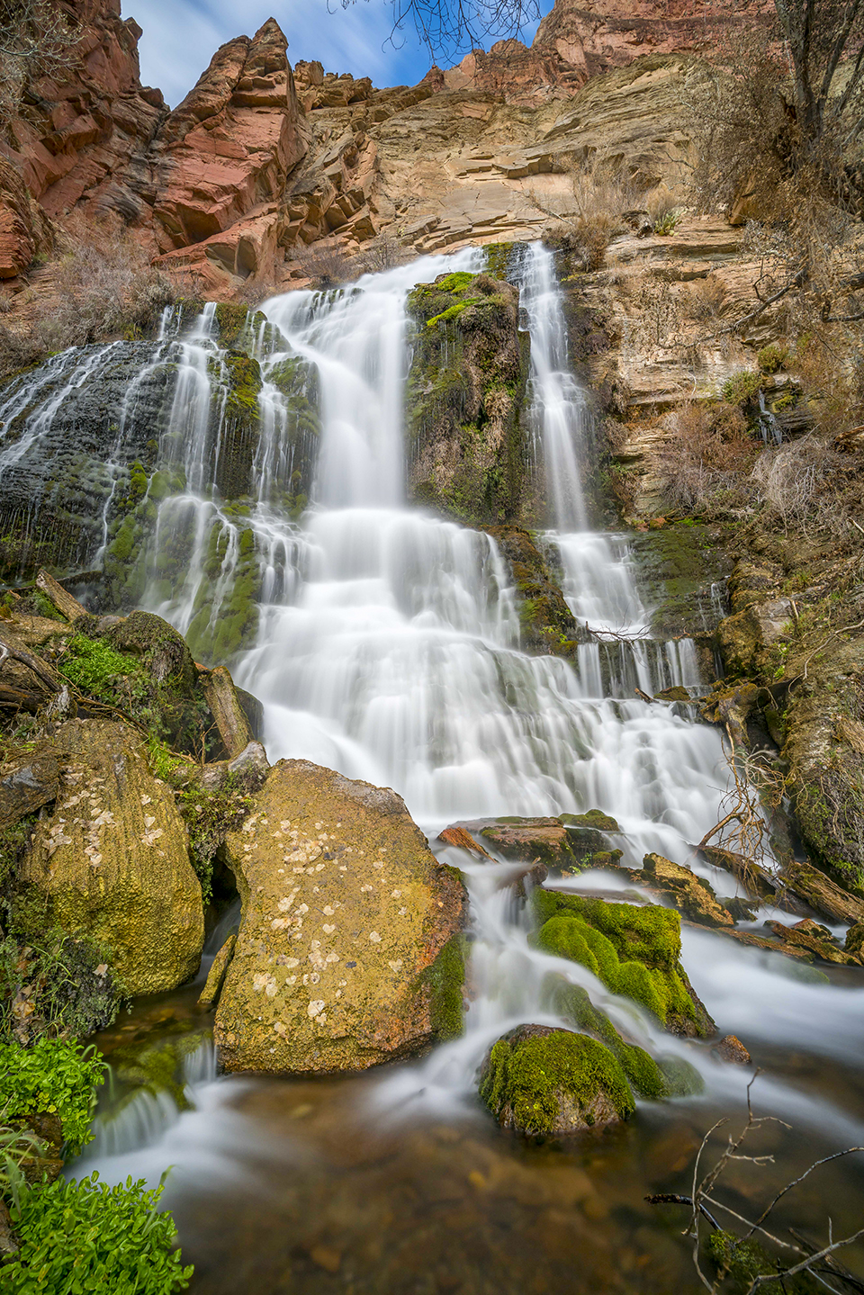Mosses and other riparian plants thrive along part of Thunder River Falls in a view from below. The river’s spring flows year-round, making the waterway a perennial river. By Rich Rudow