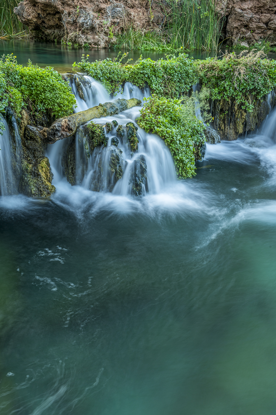 Spring-fed Fossil Creek tumbles over travertine dams and waterfalls amid the greenery of the Fossil Springs Wilderness, near Strawberry. The springs that feed Fossil Creek flow at a rate of about 20,000 gallons per minute, making this area a haven for both wildlife and backpackers. By Laurence Parent