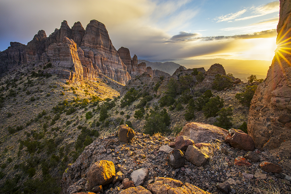Dramatic formations in the Mount Tipton Wilderness, northwest of Kingman, glow at sunrise as a spring storm passes overhead. This topographically challenging, 31,000-acre wilderness area offers numerous opportunities for hikers, equestrians and photographers. By Joel Hazelton
