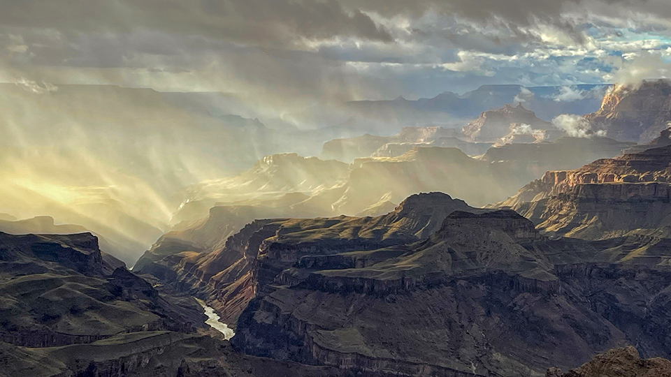 Swirling clouds and sunlight combine for a dramatic view of the Grand Canyon in a view from Lipan Point. Honorable Mention in the Arizona Highways 17th Annual Photo Contest by Kenton Krueger 