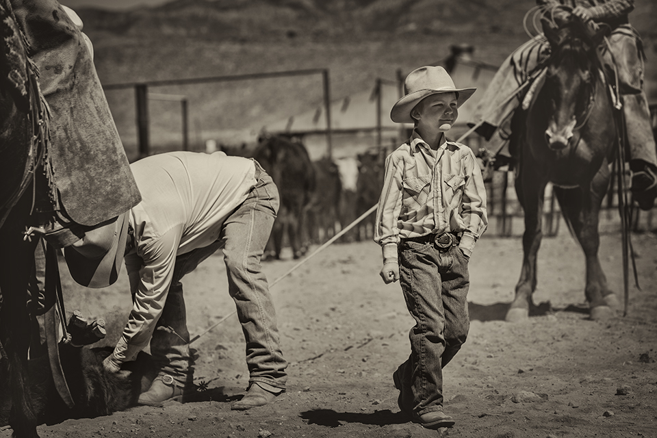 Gideon Smith, Ella’s younger brother, works in the branding corral under the tutelage of Ed Ashurst. By Scott Baxter