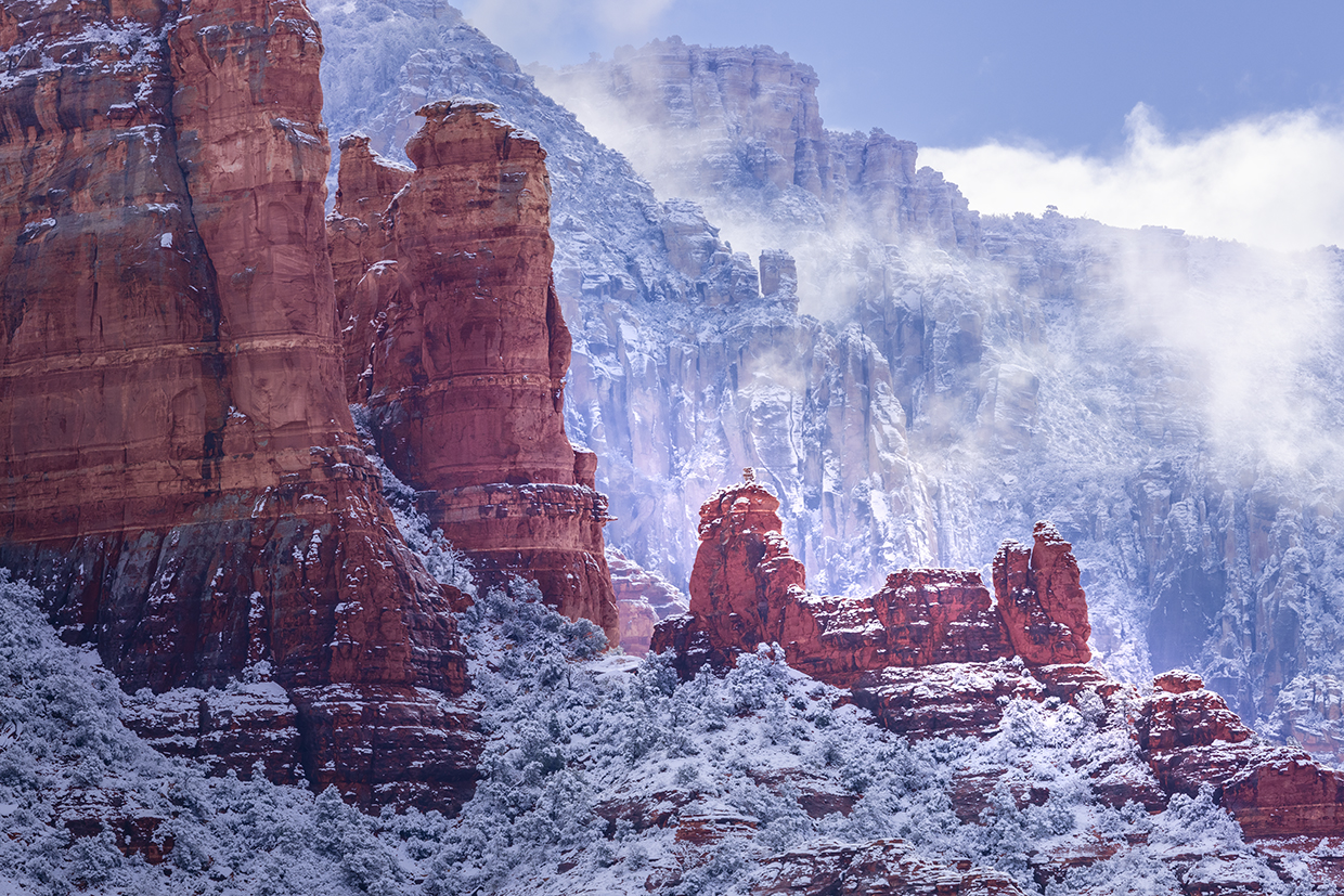 Fog and snow-covered foliage combine to form a wintry scene amid the sandstone buttes of Red Rock Country. The formations seen in the foreground are part of Snoopy Rock, named for its resemblance to the Peanuts character. | Larry Lindahl