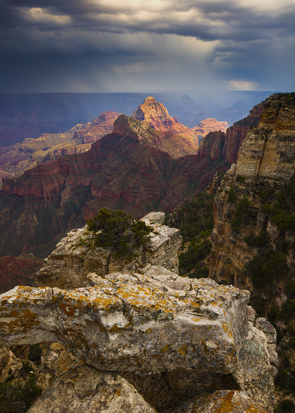 An overlook on the North Rim offers a view of Vishnu Temple and rainfall from a monsoon storm. The summer monsoon, from mid-July through the end of September, is when afternoon thunderstorms at the Canyon are most common. By Adam Schallau