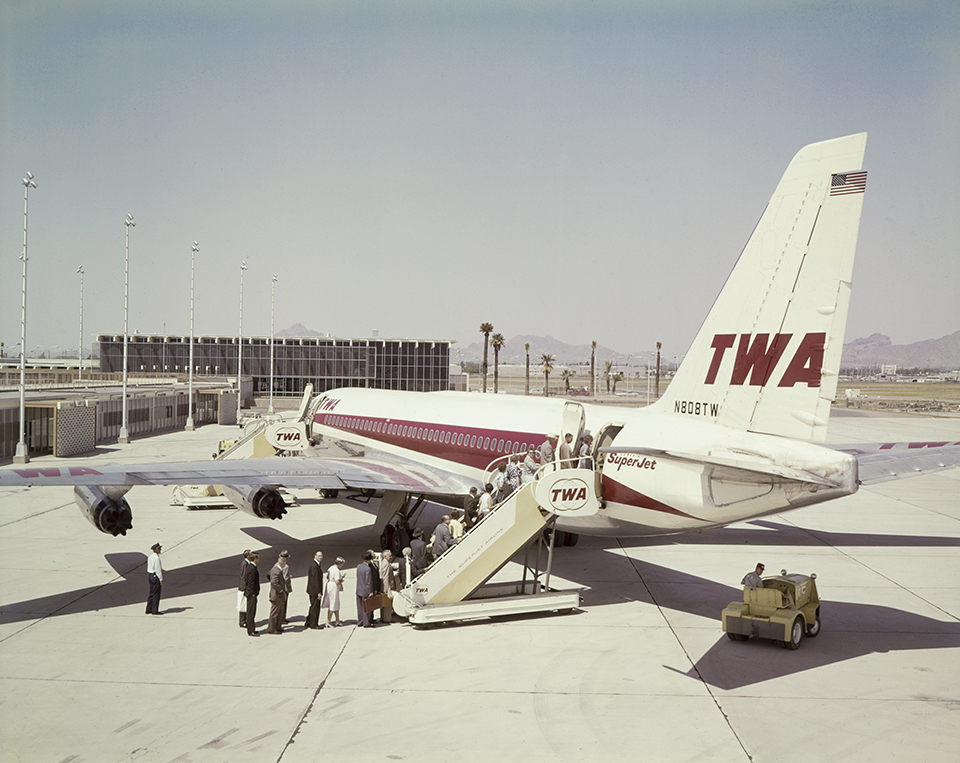 Travelers board a TWA Convair 880 at Sky Harbor Municipal Airport (now Phoenix Sky Harbor International Airport). In the background is the airport’s Terminal 2, which opened in 1962; the same year, Sky Harbor handled more than 1 million passengers for the first time. By Herb and Dorothy McLaughlin