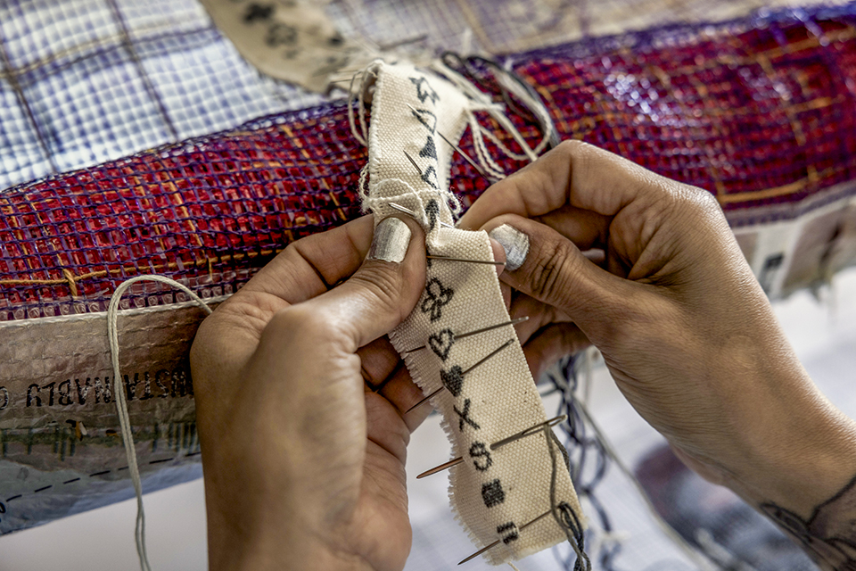 Martinez-Granados does cross-stitching for an ongoing art piece at her studio in Phoenix. | Adriana Zehbrauskas