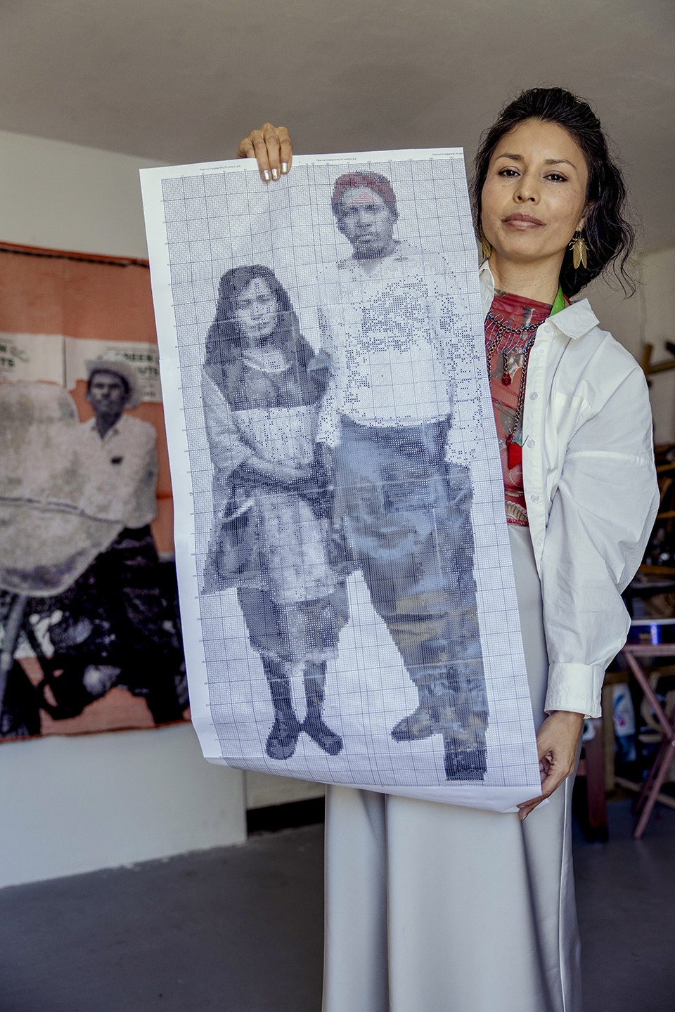 The artist displays a cross-stitch pattern of her paternal grandparents, who worked in the U.S. via the bracero program in the mid-20th century. | Adriana Zehbrauskas