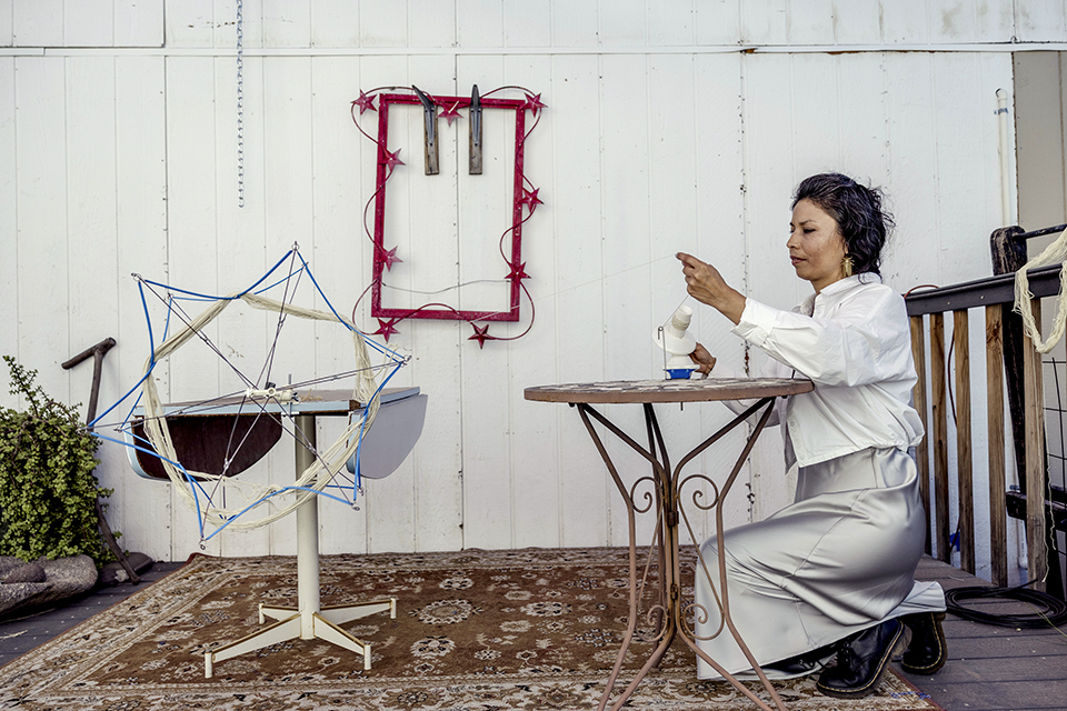 Martinez-Granados works with dyed thread at her studio. She says she hopes her work inspires a sense of connection, particularly for other immigrants. | Adriana Zehbrauskas