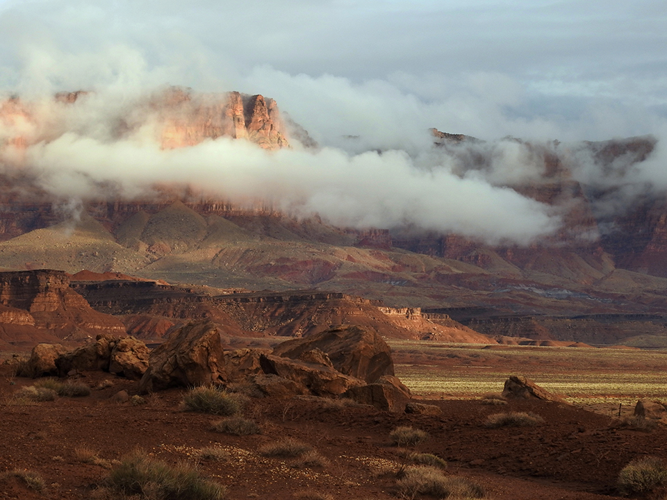 Stormy Weather along the Vermilion Cliffs in Northern Arizona reveals their rocky crests. By Pam Barnhart 