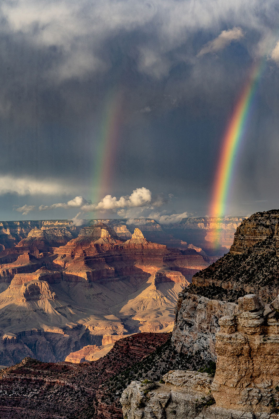 A double rainbow descends from stormy skies at the South Rim of the Grand Canyon. By Patty Albin 