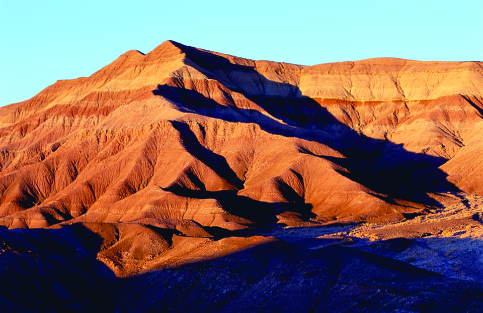 Shadows form in the red rock badlands (right) on the Hopi Indian Reservation. | Gary Johnson