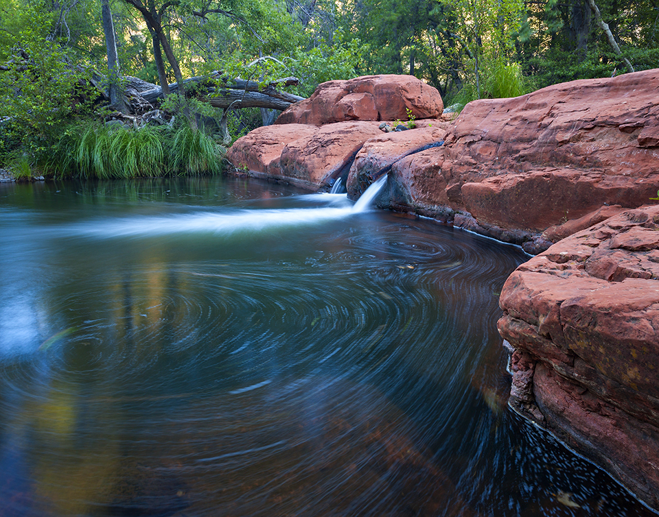 The water of Wet Beaver Creek pours over sandstone into a swirling pool. | Derek von Briesen