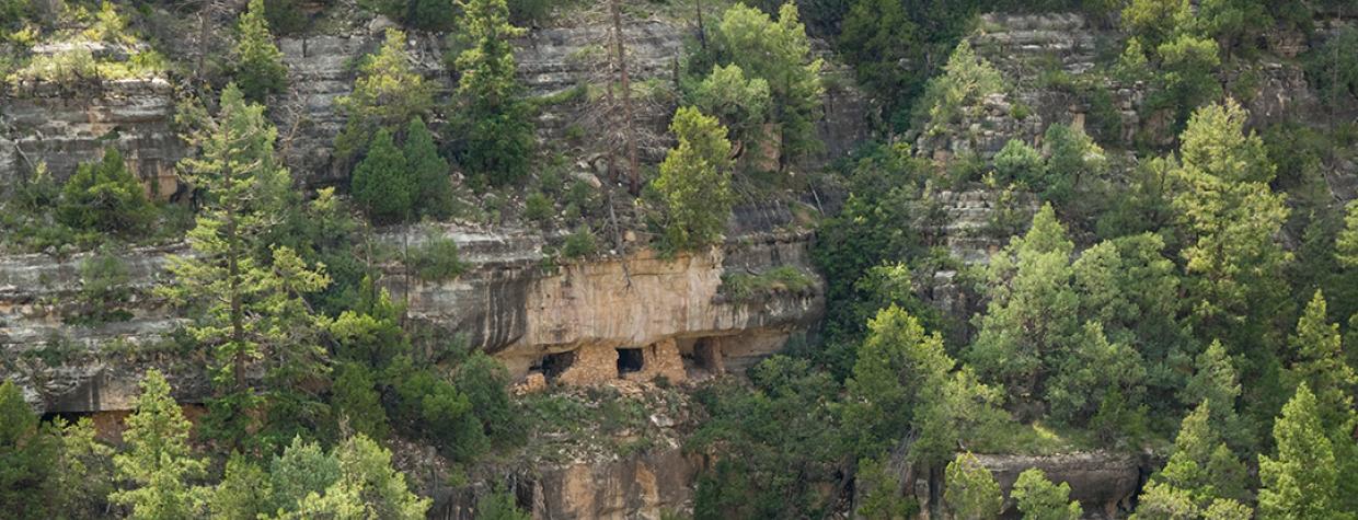 What remains of a Sinaguan cliff dwelling clings to the canyon wall at Walnut Canyon National Monument. This view is from the Island Trail, which traverses another set of ruins. | Tom Bean