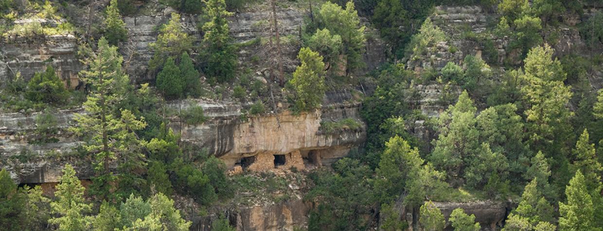 What remains of a Sinaguan cliff dwelling clings to the canyon wall at Walnut Canyon National Monument. This view is from the Island Trail, which traverses another set of ruins. | Tom Bean