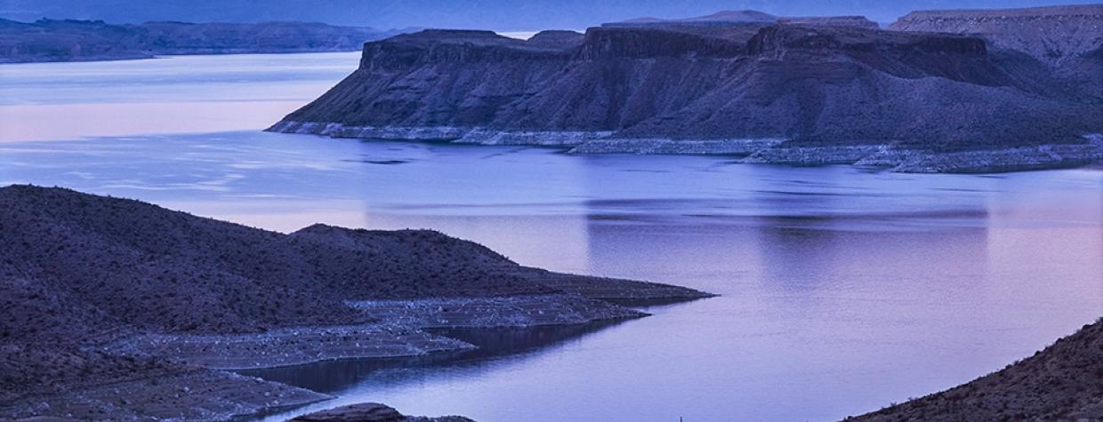 A dirt road winds toward Gregg's Hideout, a remote bay on Lake Mead, at sunset. | Larry Lindahl