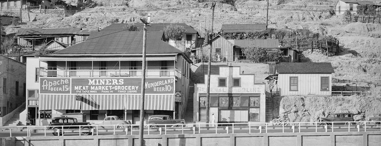 A sign on a building advertises Apache Beer.