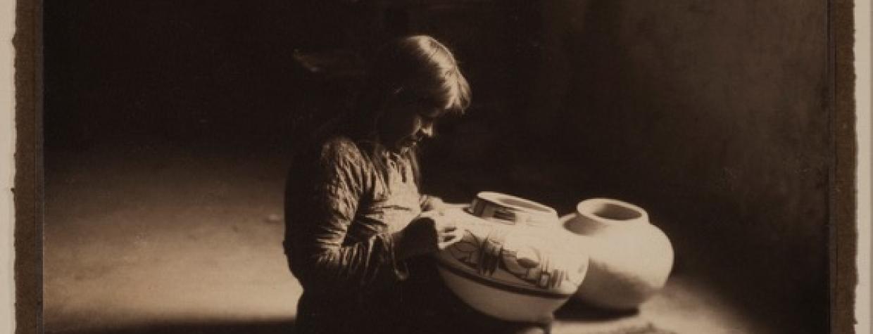 A sepia toned image shows a portrait of a young potter