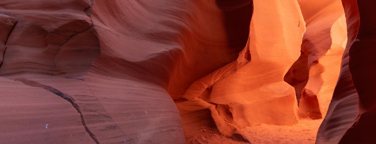 A color photographs show the intricate sandstone geology of Antelope Canyon, a slot canyon in Northeastern Arizona. 