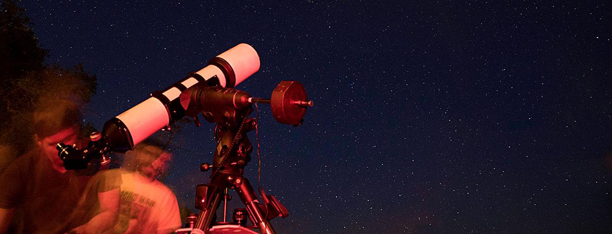 A visitor to the North Rim of Grand Canyon National Park looks through a telescope during the Grand Canyon Star Party. Photograph by John Burcham.