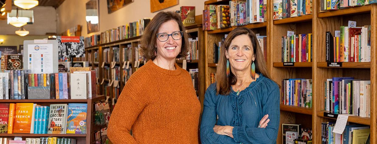 Lisa Lamberson and Annette Avery in front of bookshelves at their shop. Photograph by John Burcham.