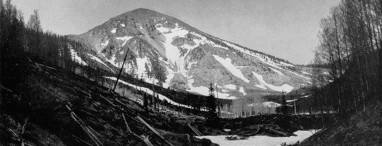 Snow covers a streambed in the Inner Basin of the San Francisco Peaks. “A pipeline beneath the white mantle supplies the Flagstaff reservoir,” Arizona Highways reported in 1936. By Norman G. Wallace