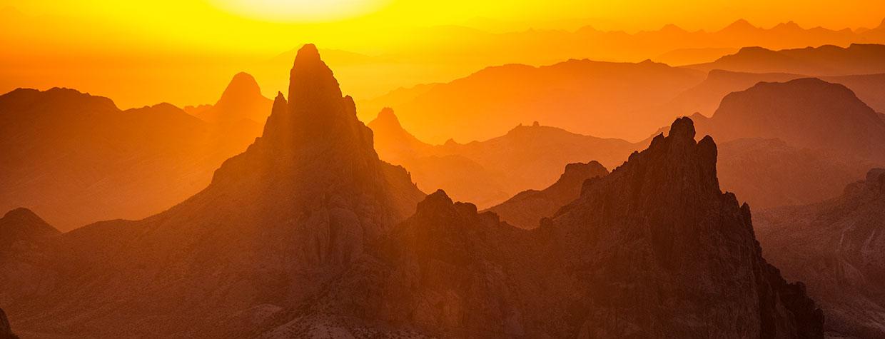 Sunrise in the Kofa Mountains displays layered hues of yellow, orange and brown. By Joel Hazelton