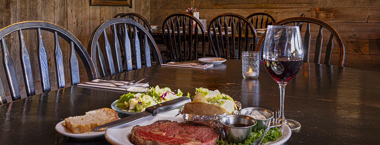 Prime rib, baked potato, salad and all the fixins' plus a glass of red wine at Molly Butler Lodge and Restaurant. By John Burcham