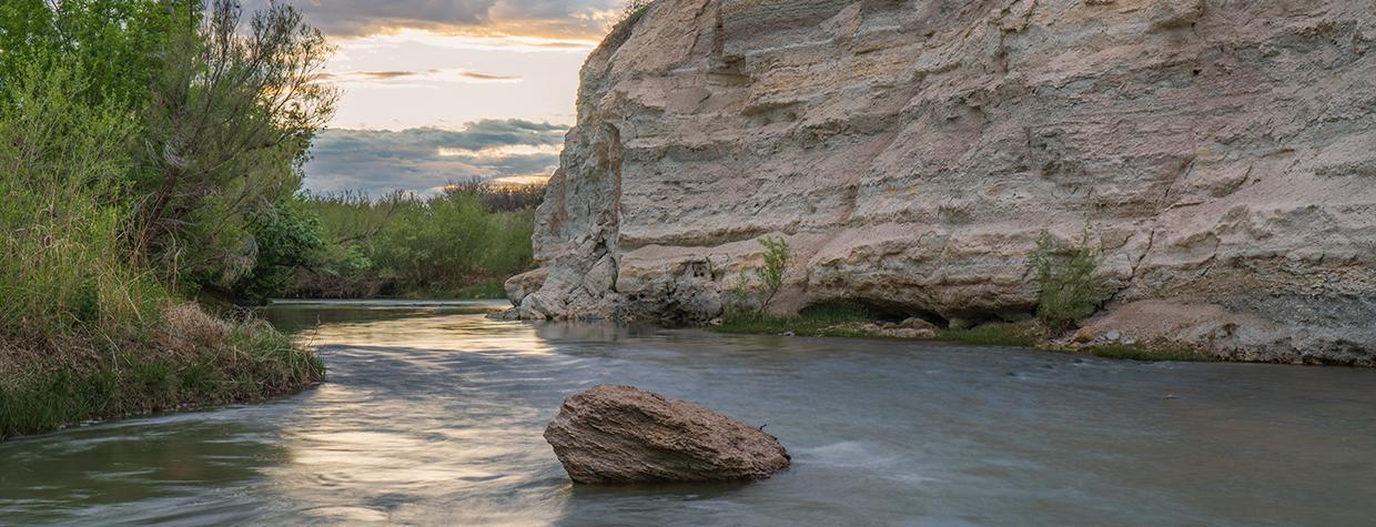 The Verde River flows past the imposing namesakes of the White Cliffs Trail. By Laurence Parent
