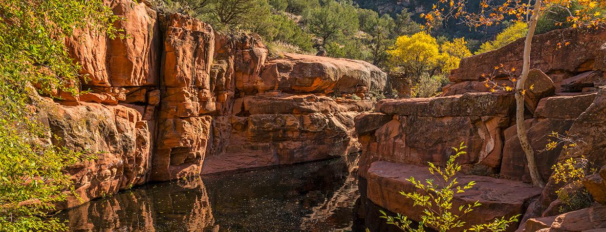 Fall color surrounds Wet Beaver Creek’s “The Crack,” a highlight of the Bell Trail. By Laurence Parent