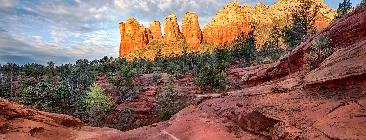 The Seven Sacred Pools, a landmark  on the Soldier Pass Trail, mirror the spires of Coffeepot Rock. By Larry Lindahl
