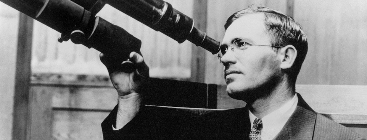 Clyde Tombaugh peers through a 6-inch telescope at the  University of Kansas, where he earned bachelor’s and master’s degrees. This photo was made in 1936, six years after Tombaugh’s discovery  of Pluto at Flagstaff’s Lowell Observatory. | New Mexico State University