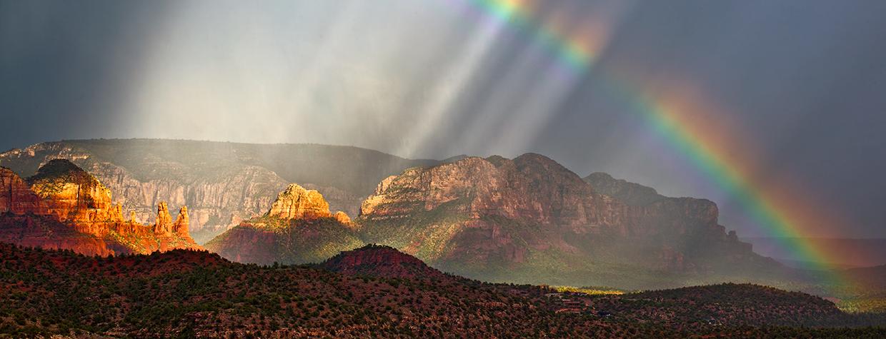 Falling rain and a rainbow bring a dreamlike vibe to a view of Red Rock Country. Such otherworldly views may be part of the reason the Sedona area has become a destination for those seeking paranormal experiences. | Guy Schmickle