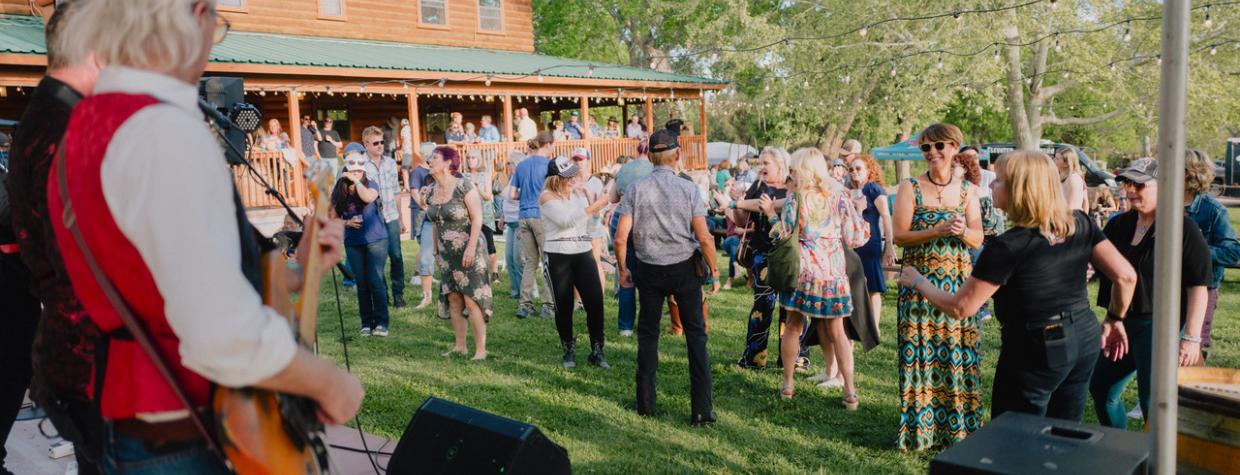 Revelers enjoy live music at a wine tasting event