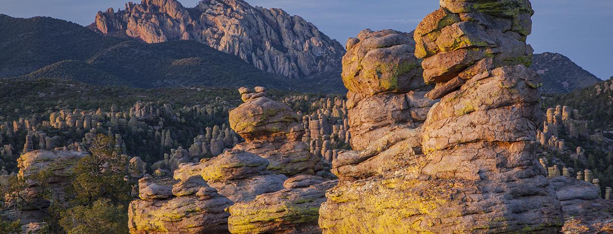 Cochise Head looms over the hoodoos along Chiricahua National Monument’s Heart of Rocks Loop at sunset. | Laurence Parent